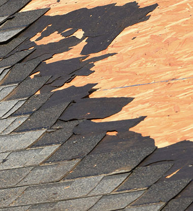 Visible shingle damage before roof repair in Utah County