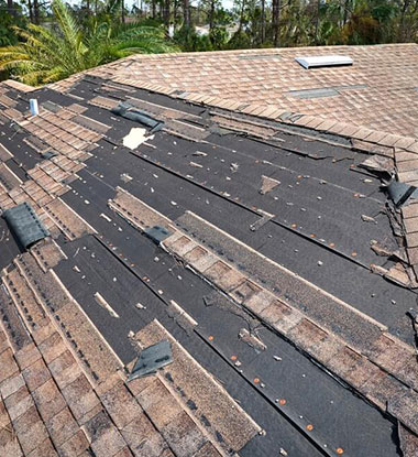 Storm damaged roof with missing shingles in Salt Lake County
