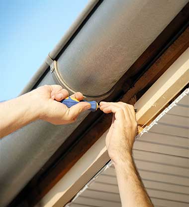 Gutter system being fitted to a home in Salt Lake County