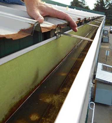Gutter repair work underway on a residential roof in Utah County