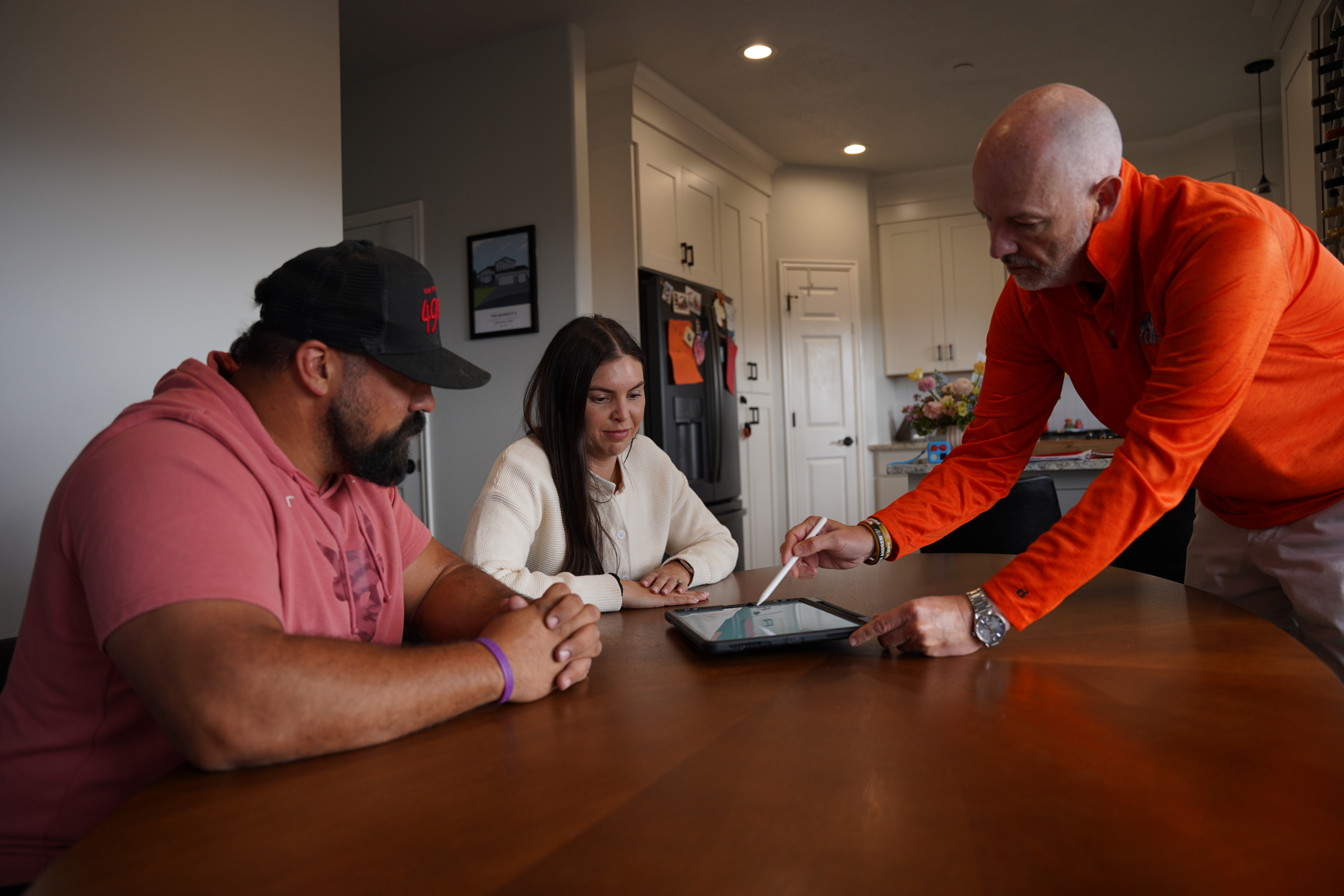 Roof Hounds employee explains roofing services to homeowners in salt lake county