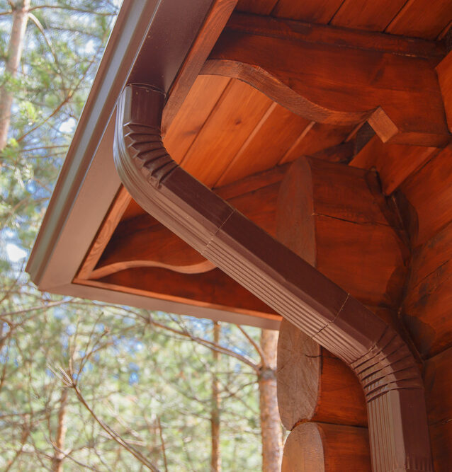 aluminum gutters expertly installed on a log cabin home in salt lake county