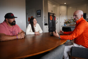 Roof Hounds employee discusses financing options for roofing services with homeowners in salt lake county