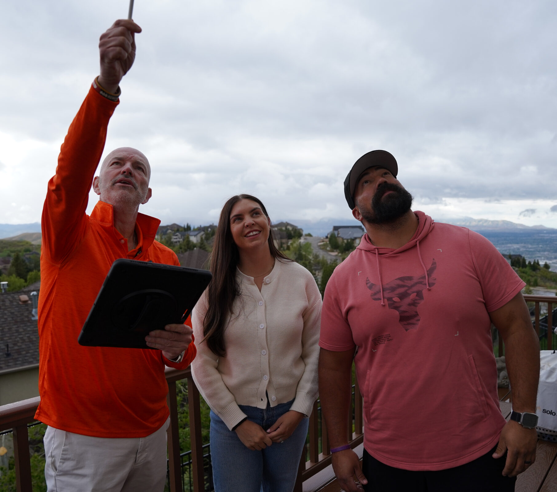 Roof Hounds employee explaining gutter guard options to homeowners in salt lake county